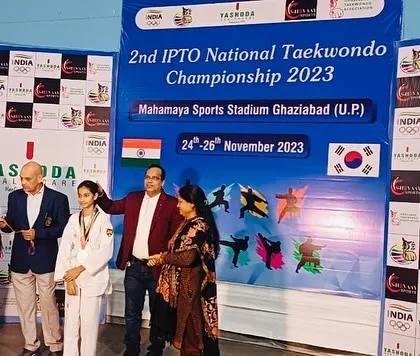 The joy of achievement. A student receives her medal at the Mahamaya Sports Stadium, representing our academy with pride and skill.