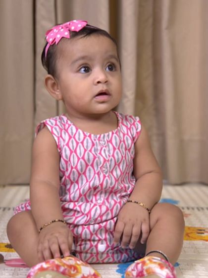 Another sweet shot of a baby in our pink printed romper. The comfortable fit allows for plenty of movement as your little one explores the world.