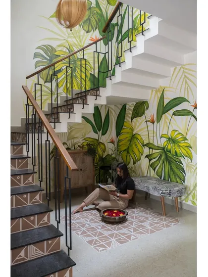 I believe every part of a home can be a piece of art. For this staircase, we commissioned a custom, hand-painted mural that turns a simple transition space into a vibrant, biophilic experience, bringing the tranquility of nature indoors.