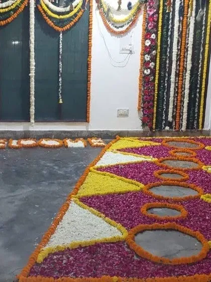 A floral rangoli or 'phoolon ki chaadar' we created in the hallway of a home for a wedding function. We used petals of different colored flowers to make a vibrant pattern on the floor, surrounded by marigold garlands.