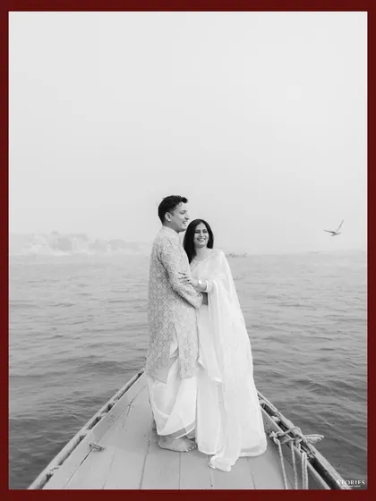 A timeless black and white portrait of Kapil and Ritika on a boat in Varanasi, capturing a quiet moment on the sacred Ganges.