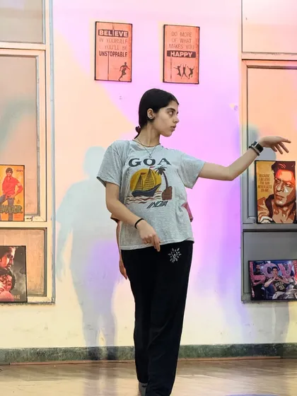 A student practicing her moves in class. The studio is decorated with posters of dance legends, creating an inspiring environment for all of us.