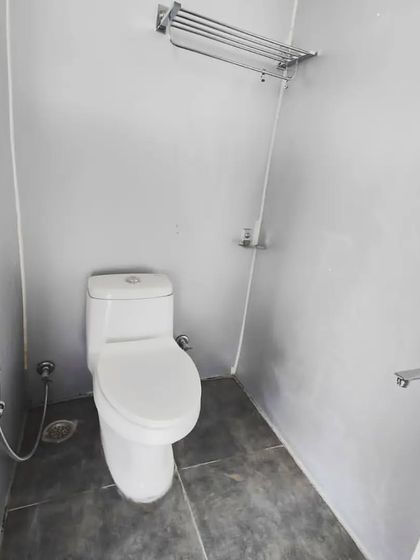 A look inside the attached washroom of one of our prefab rooms, featuring modern fixtures and a clean, minimalist design.
