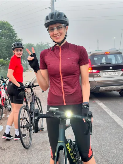 A rider flashes a peace sign while her friend looks on.