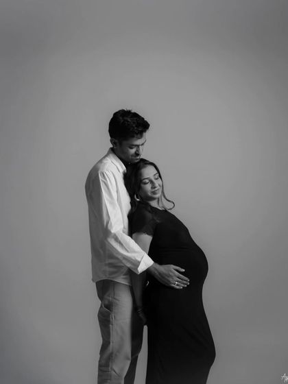 A quiet, intimate embrace captured in a black and white portrait. This image focuses on the emotional connection and the feeling of safety and love between the couple.