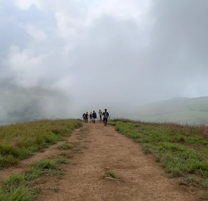 The trail ahead, disappearing into the mist. This shot captures the sense of mystery and adventure that comes with trekking in the monsoons.