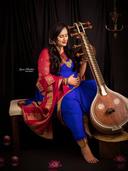 Another beautiful angle from our Veena-themed maternity shoot. The composition creates a sense of harmony between the artist, her music, and the new life she carries.
