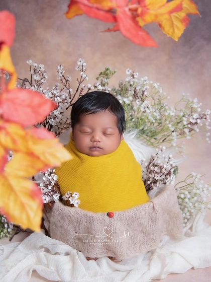 Snug as a bug in a mustard-colored wrap. The pop of yellow is so cheerful, and the tiny ladybug detail adds a touch of good luck.