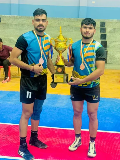 Two of my players with the championship trophy from the East Zone University Games.
