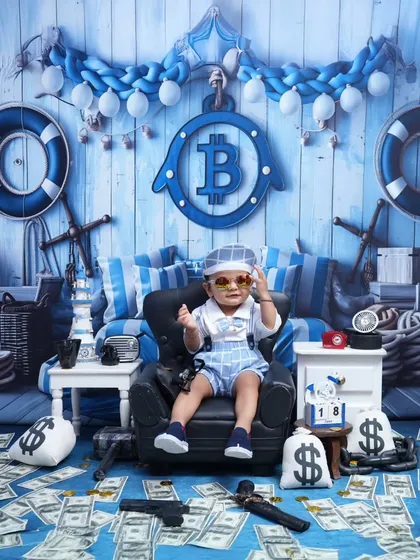 The ultimate Boss Baby portrait. With sunglasses on and surrounded by money, this little guy is the picture of confidence and charm.