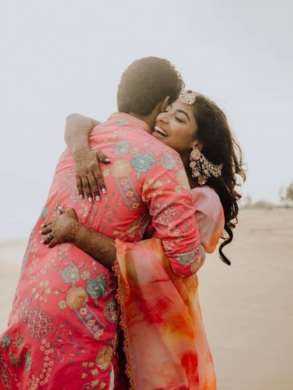 A warm, happy hug on the beach. The joy of being together, captured in a simple, beautiful moment.