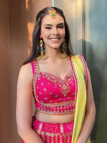 Bright and beautiful for Mehendi. This look features soft shimmer eyes with a pop of color, paired with a natural base and soft nude lips.
