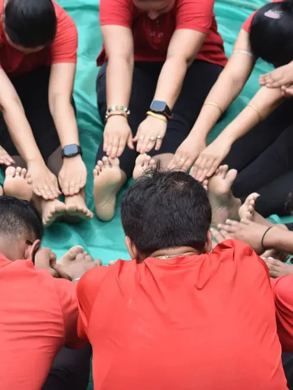 A close-up of our group performing a seated forward bend, a great stretch for the hamstrings and back.