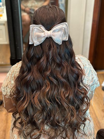 The bow accessory is the perfect finishing touch for this celebratory and feminine look.