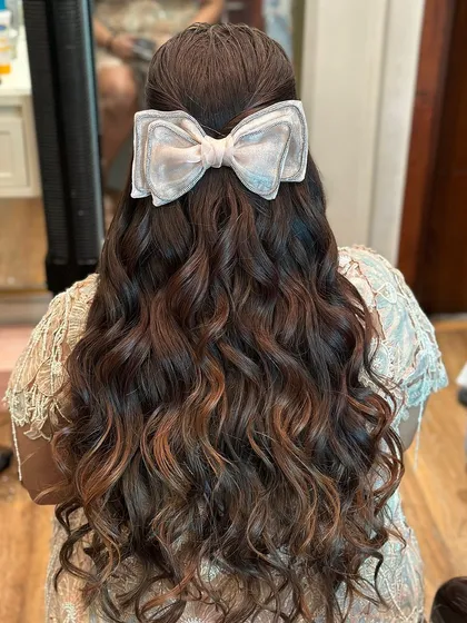 The bow accessory is the perfect finishing touch for this celebratory and feminine look.