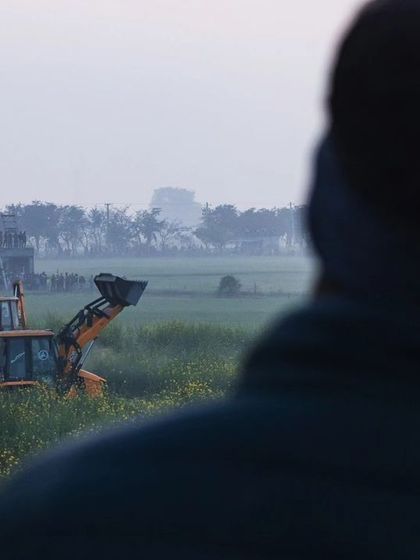 JCBs are brought in to help manage the area during the tiger rescue, a stark image of machinery in a supposed wildlife habitat.