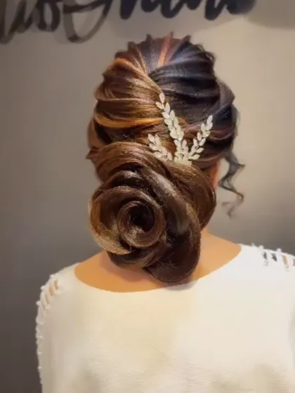 A side view of the finished rose bun, showing the clean lines and beautiful shape.