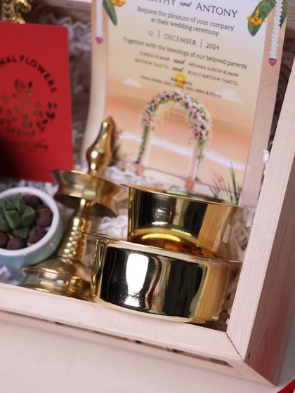 Another close-up of the wedding invitation hamper, focusing on the quality and shine of the included brassware.