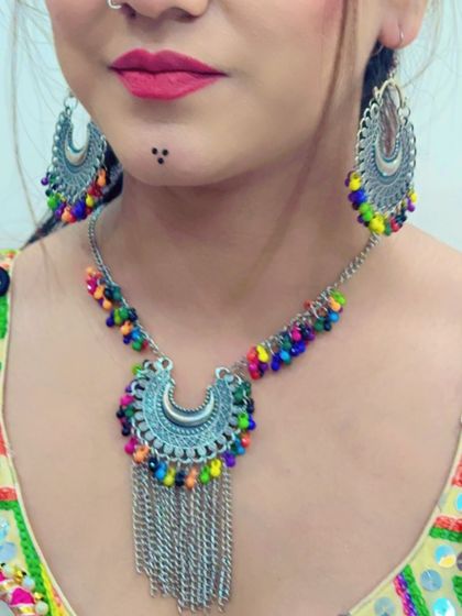 A close-up of the necklace and earrings with multi-colored beads, showing how they brighten up the entire look.