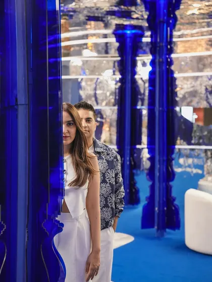 Another perspective on our portrait behind the translucent blue pillar. This shot emphasizes the layers and depth we build into our spaces, creating a rich visual narrative for people to discover.