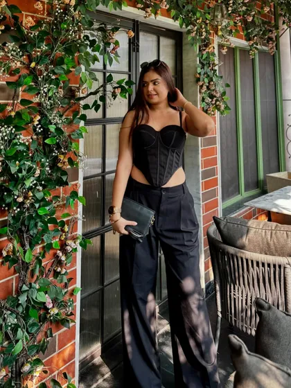 A different angle of the all-black look, showing confidence and style.