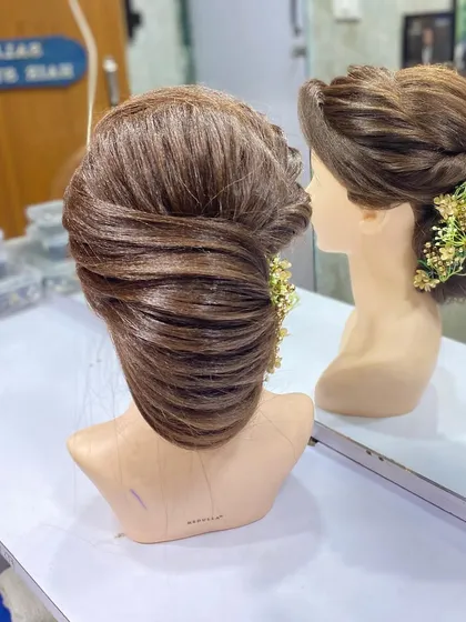 A classic, side swept updo created by one of my students. This timeless style is a staple for any event hairstylist.