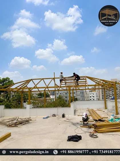 A wide view of the construction site, with our team assembling the large pergola frame on the terrace.