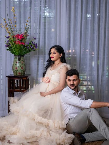 A stylish portrait of the couple in the studio. The combination of the elegant gown and his smart-casual attire makes for a modern and sophisticated shot.