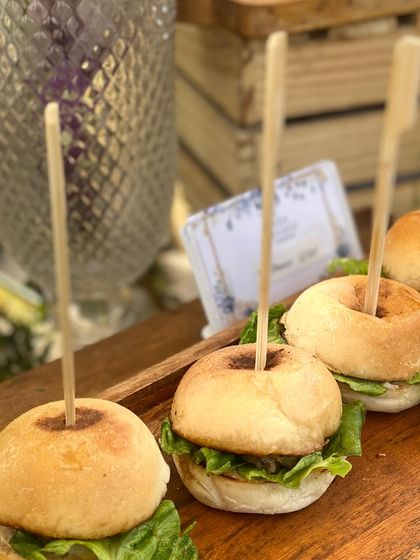 A close-up of our mini chicken sliders, a popular choice for winter lunches and casual parties. The soft buns, fresh lettuce, and savory patty make for a perfect bite-sized treat.