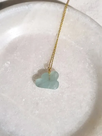 My aquamarine cloud pendant, a symbol of lightness and clarity. I chose aquamarine for its ability to wash away stress and calm the mind, like the sky after a storm.