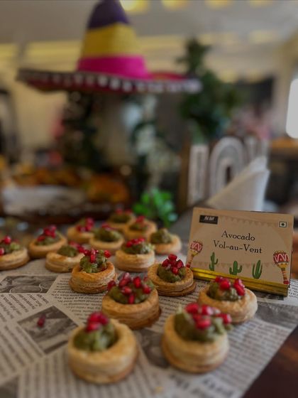 A close-up of the Avocado Vol-au-Vents from our Mexican grazing table. Each bite-sized pastry is filled with fresh guacamole and topped with pomegranate seeds, showcasing our attention to detail and flavor.