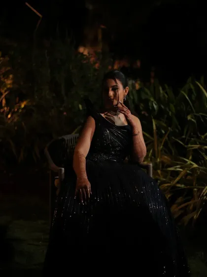 An atmospheric shot of our bride at her cocktail event. The dark, sequined gown is paired with a sophisticated makeup look that glows even in low light.