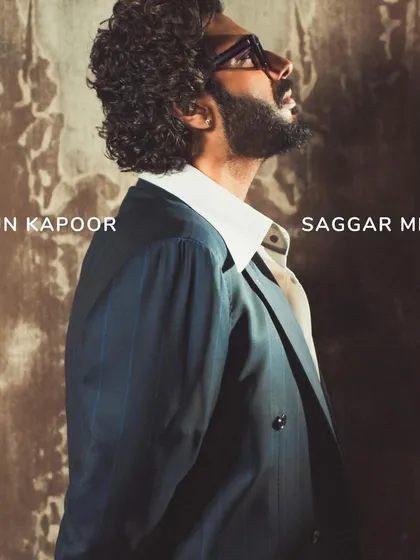 A profile view that emphasizes the sharp cut of the suit jacket and the distinctive shape of the collar. It’s all in the details.