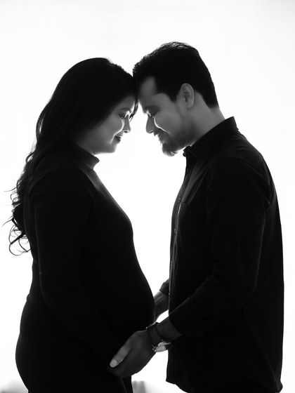 A beautiful black and white silhouette of the couple, forehead to forehead. This intimate pose creates a powerful feeling of connection and shared love.