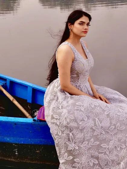 The wind catching the hair of the model perfectly complements the delicate feel of this grey lace gown. The custom-fit bodice and full skirt are designed to be flattering from every angle, making it an ideal choice for a pre-wedding or engagement shoot.