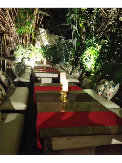 An intimate seating arrangement in a secluded garden nook. We are adept at creating cozy and private dining spaces within a larger event area for special guests.
