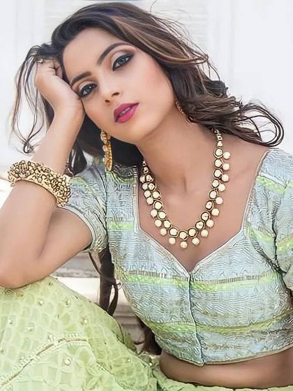 A beautiful shot from a model photoshoot. The makeup features a classic smokey eye and a bold lip, paired with soft waves, creating a timelessly glamorous look.