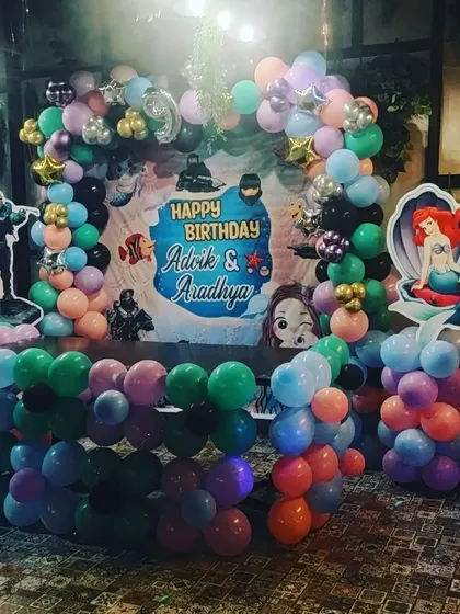 Another angle of the Halo and Mermaid party setup, showing the balloon arrangement and character props.