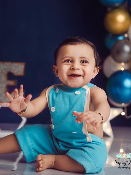 The pure joy on this little one's face is why we do what we do. A happy, smiling baby in a simple and modern birthday setup.