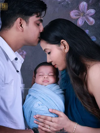 A loving family portrait with both parents gently holding their newborn. These photos focus on the unity and joy of the new family, creating a cherished keepsake.