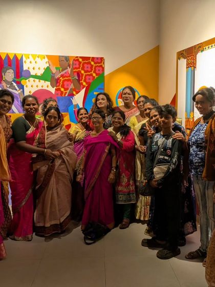 A group of proud women from the Haan Hum collective posing at a gallery show. Seeing their art and their stories on the walls is a powerful act of validation and empowerment.