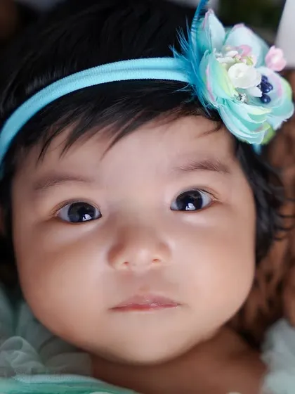 A stunning close-up that captures the beautiful, soulful eyes of this two-month-old baby girl.