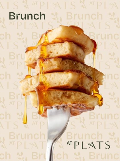 A simple, iconic image of pancakes drizzled with syrup, representing the sweet side of our brunch offerings.