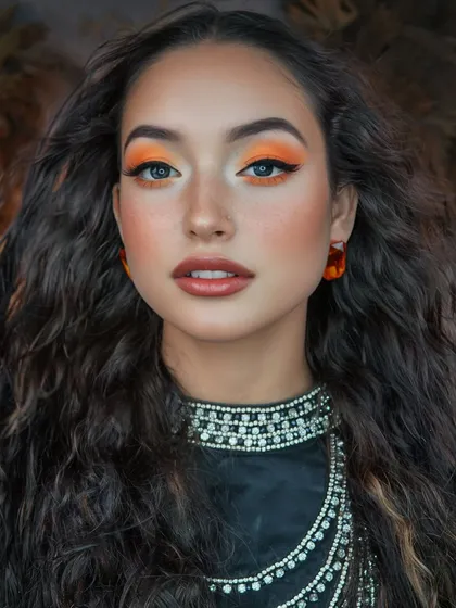 A portrait shot of the sunflower look, focusing on the sharp winged liner and the beautiful contrast between the orange eyeshadow and the model's eye color.
