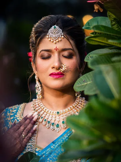 A stunning portrait of my South Indian bride Amileen, surrounded by lush greenery. Her vibrant blue saree and diamond jewellery create a breathtaking look.