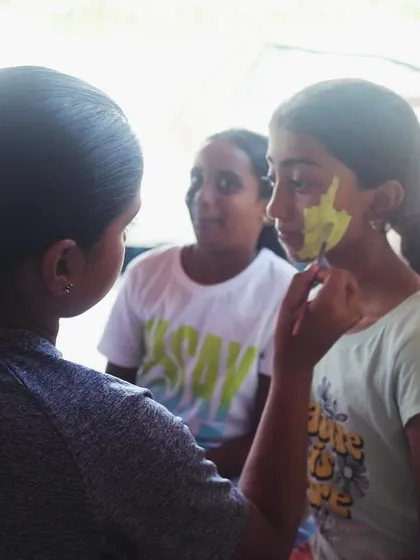 Another scene from our face painting session, where campers unleash their inner artists.