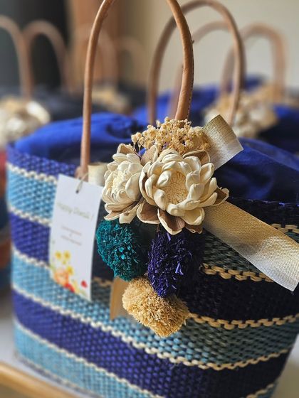 Another color variation of the popular raffia baskets. The shades of blue and the earthy tones of the tassel make this a versatile option for both festive and wedding gifting.