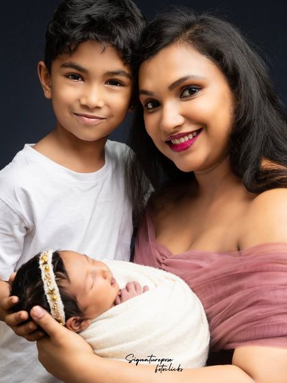 A tender moment between a mother, her newborn, and her proud son. These are the precious memories that make up a family's story.