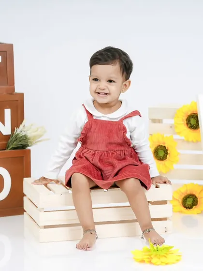 A slightly different pose from the second birthday session, showing her playful personality.