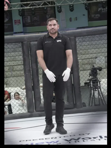 A portrait of our coach in his official VFC referee uniform, ready for action inside the cage.